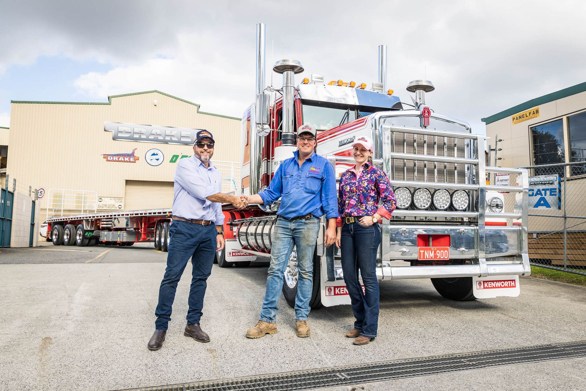 Byron hands over a bright red O'Phee B Double for T&M Earthmoving and Rural Contracting