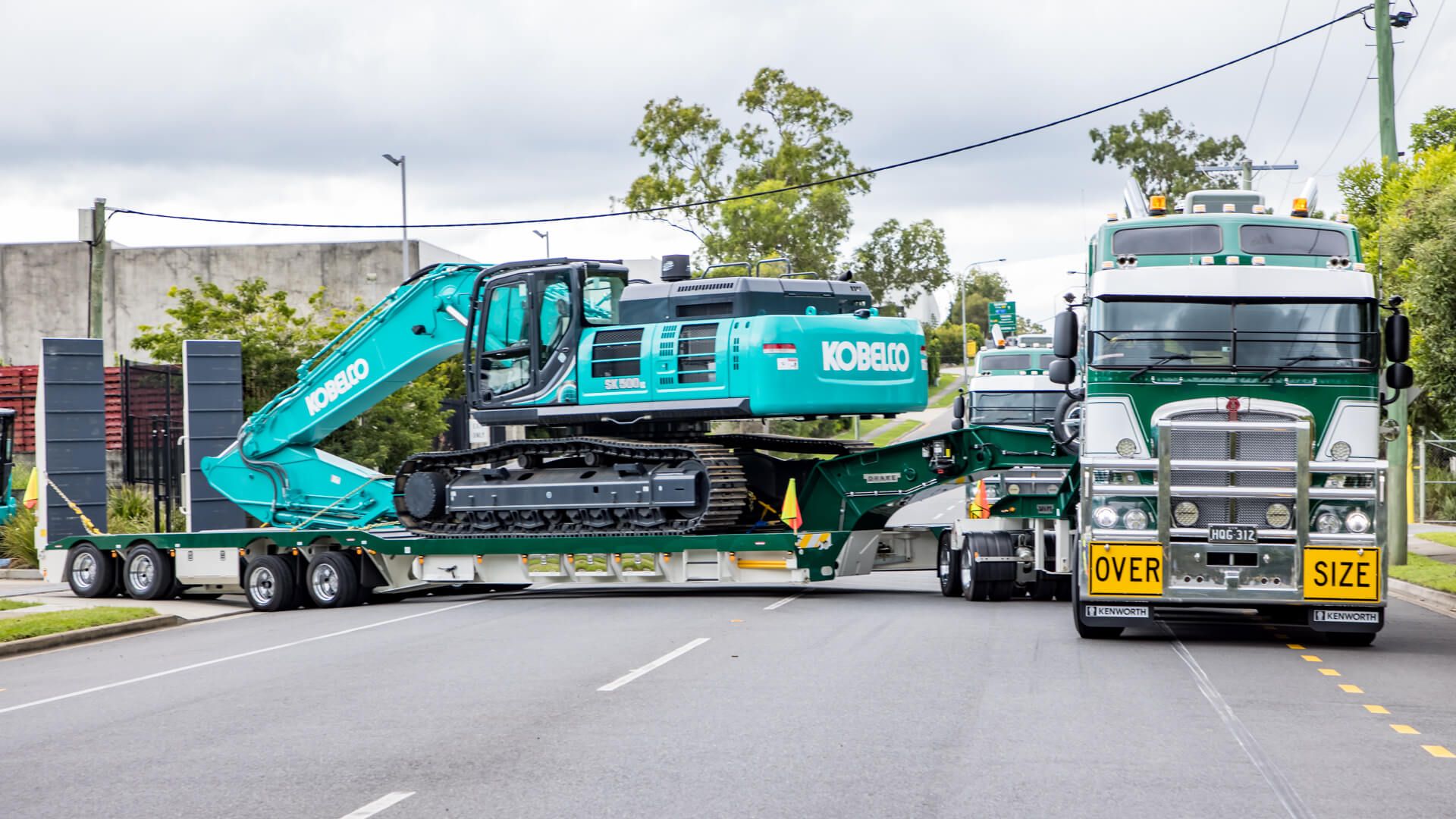 Hi Quality's Green 4x8 SwingWing carrying their crane